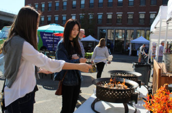 Two girls toast marshmallows.